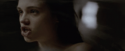 A Close Up Of A Woman 'S Face With The Number 8 In The Background GIF