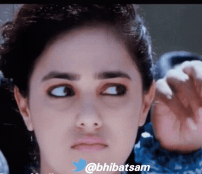 A Close Up Of A Woman 'S Face With The Twitter Username @Bhibatsam Visible GIF