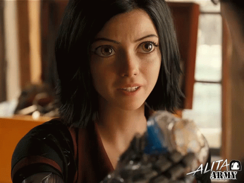 A Close Up Of A Woman 'S Face With The Word Alita Above Her GIF