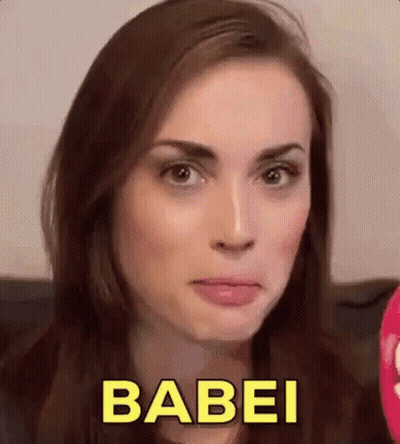 A Close Up Of A Woman 'S Face With The Word Babei In Yellow Letters . GIF