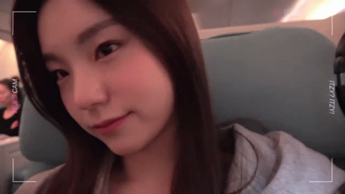 A Close Up Of A Woman 'S Face With The Word Izzueazui Visible GIF