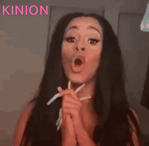 A Close Up Of A Woman 'S Face With The Word Kinon Written Above Her GIF