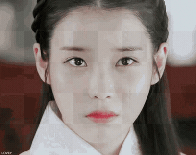 A Close Up Of A Woman 'S Face With The Word Lovey On The Bottom Left GIF