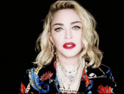 A Close Up Of A Woman 'S Face With The Word Madame On Her Neck GIF