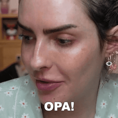 A Close Up Of A Woman 'S Face With The Word Opa Written Below It GIF