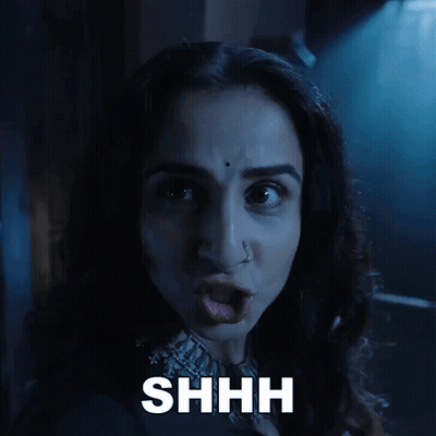 A Close Up Of A Woman 'S Face With The Word Shhh Above Her GIF