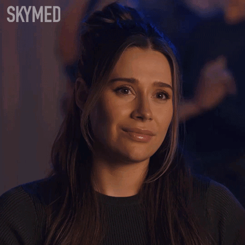 A Close Up Of A Woman 'S Face With The Word Skymed Behind Her GIF