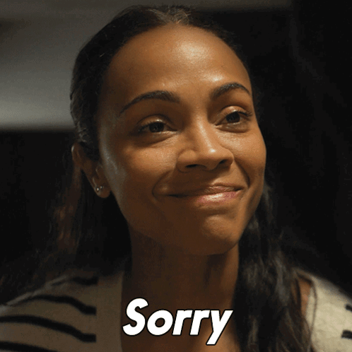 A Close Up Of A Woman 'S Face With The Word Sorry In White Letters GIF