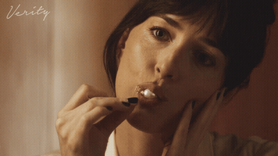 A Close Up Of A Woman 'S Face With The Word Verity On The Bottom Right GIF