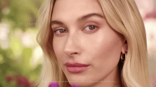 A Close Up Of A Woman 'S Face With The Words " 100 % Of Users Win " Behind Her GIF