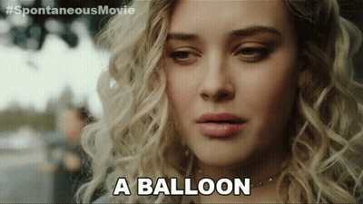 A Close Up Of A Woman 'S Face With The Words " A Balloon " Next To Her GIF