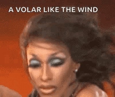 A Close Up Of A Woman 'S Face With The Words `` A Volar Like The Wind '' Behind Her . GIF