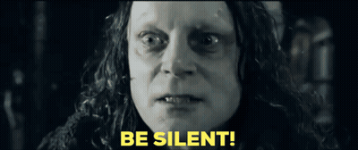 A Close Up Of A Woman 'S Face With The Words Be Silent In Yellow Letters GIF