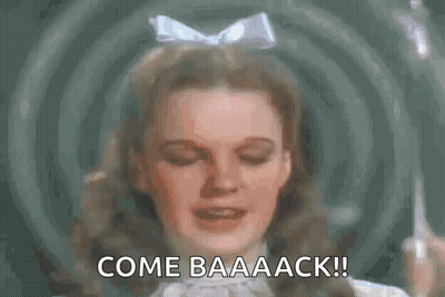 A Close Up Of A Woman 'S Face With The Words `` Come Baaaack '' Written Above Her . GIF
