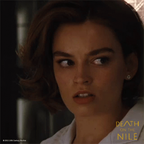 A Close Up Of A Woman 'S Face With The Words Death On The Nile GIF