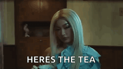 A Close Up Of A Woman 'S Face With The Words Heres The Tea Written Below Her GIF