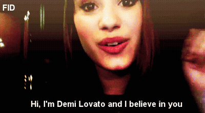 A Close Up Of A Woman 'S Face With The Words Hi I 'M Demi Lovato And I Believe In You Below Her GIF