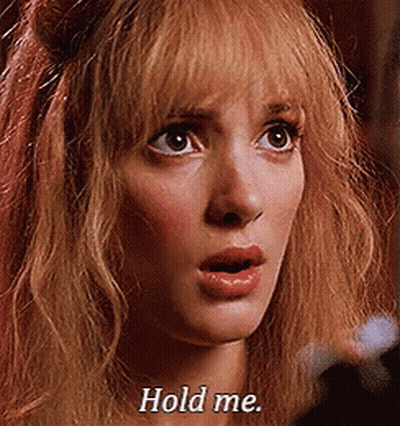 A Close Up Of A Woman 'S Face With The Words `` Hold Me '' Written On Her Face . GIF