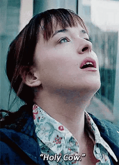 A Close Up Of A Woman 'S Face With The Words `` Holy Cow '' Written On The Bottom . GIF