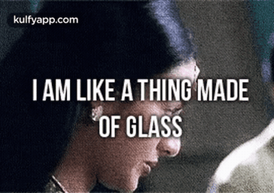 A Close Up Of A Woman 'S Face With The Words `` I Am Like A Thing Made Of Glass '' Written On It . GIF