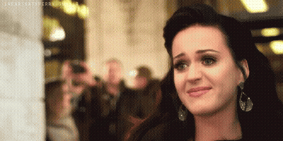 A Close Up Of A Woman 'S Face With The Words " I Heart Katy Perry " Written On The Bottom GIF
