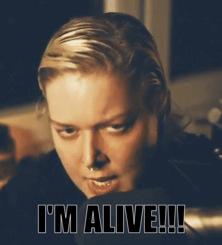 A Close Up Of A Woman 'S Face With The Words I 'M Alive Written Below Her GIF