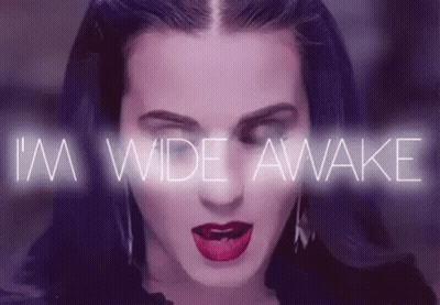A Close Up Of A Woman 'S Face With The Words `` I 'M Wide Awake '' Coming Out Of Her Mouth . GIF