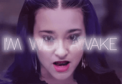 A Close Up Of A Woman 'S Face With The Words I 'M Woke Behind Her GIF