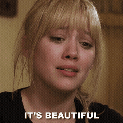 A Close Up Of A Woman 'S Face With The Words " It 'S Beautiful " Below Her GIF