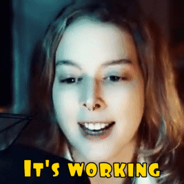 A Close Up Of A Woman 'S Face With The Words It 'S Working Above Her GIF