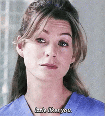 A Close Up Of A Woman 'S Face With The Words Izzie Likes You GIF