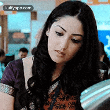 A Close Up Of A Woman 'S Face With The Words Kulfyapp.com At The Bottom GIF