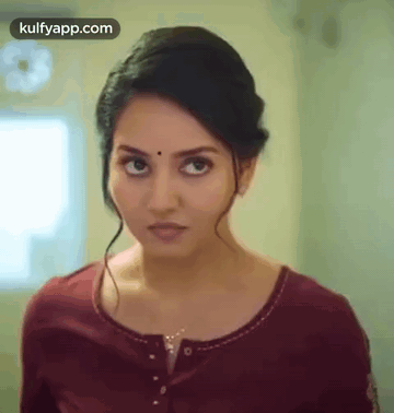 A Close Up Of A Woman 'S Face With The Words Kulfyapp.com At The Bottom GIF
