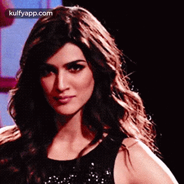 A Close Up Of A Woman 'S Face With The Words Kulfyapp.com On The Bottom Right Corner . GIF