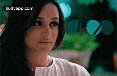 A Close Up Of A Woman 'S Face With The Words Kulfyapp.com Written On The Bottom . GIF