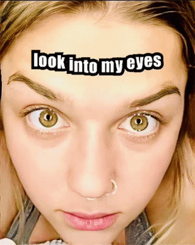 A Close Up Of A Woman 'S Face With The Words Look Into My Eyes Above It GIF