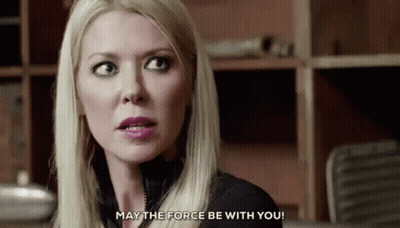 A Close Up Of A Woman 'S Face With The Words `` May The Force Be With You '' Written On The Bottom . GIF