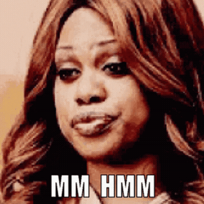 A Close Up Of A Woman 'S Face With The Words Mm Hmm Written On It GIF