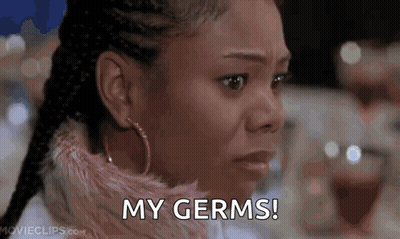 A Close Up Of A Woman 'S Face With The Words `` My Germs '' Written On Her Face . GIF