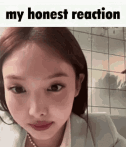 A Close Up Of A Woman 'S Face With The Words `` My Honest Reaction '' Written Above It . GIF