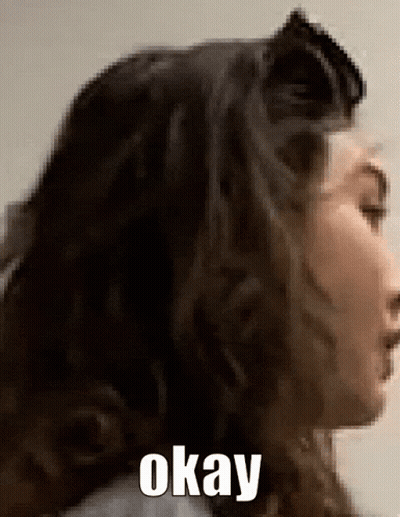 A Close Up Of A Woman 'S Face With The Words Okay Written On The Bottom GIF