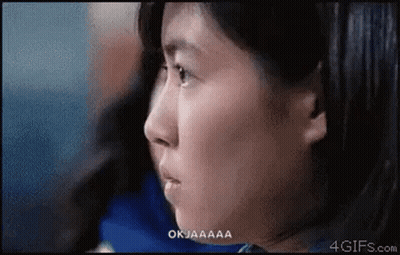 A Close Up Of A Woman 'S Face With The Words Okjaaaa Above Her GIF