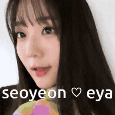 A Close Up Of A Woman 'S Face With The Words Seoyeon Eya Written Below Her GIF
