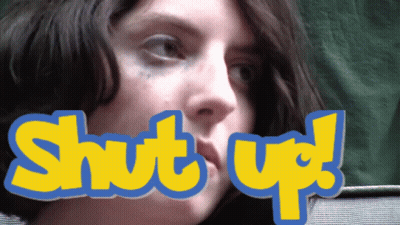 A Close Up Of A Woman 'S Face With The Words Shut Up Above Her Mouth GIF