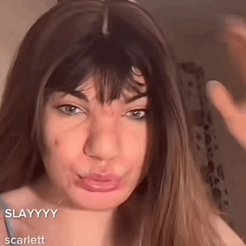 A Close Up Of A Woman 'S Face With The Words Slayyyy Scarlett GIF