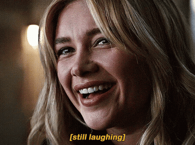 A Close Up Of A Woman 'S Face With The Words Still Laughing Below Her GIF