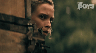 A Close Up Of A Woman 'S Face With The Words The Boys In The Background GIF