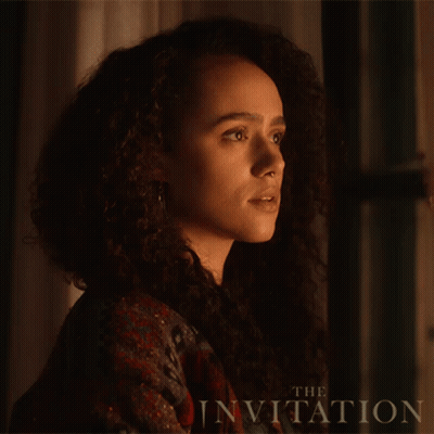 A Close Up Of A Woman 'S Face With The Words " The Invitation " Behind Her GIF