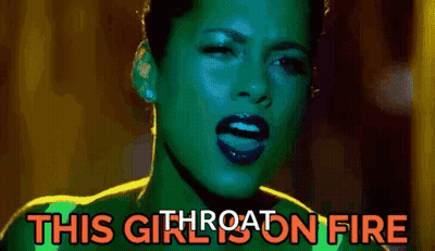 A Close Up Of A Woman 'S Face With The Words `` This Girl Is On Fire '' Written On The Bottom . GIF