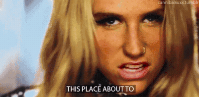 A Close Up Of A Woman 'S Face With The Words " This Place About To " On The Bottom GIF